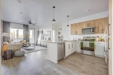 A modern kitchen with white cabinets and stainless steel appliances.