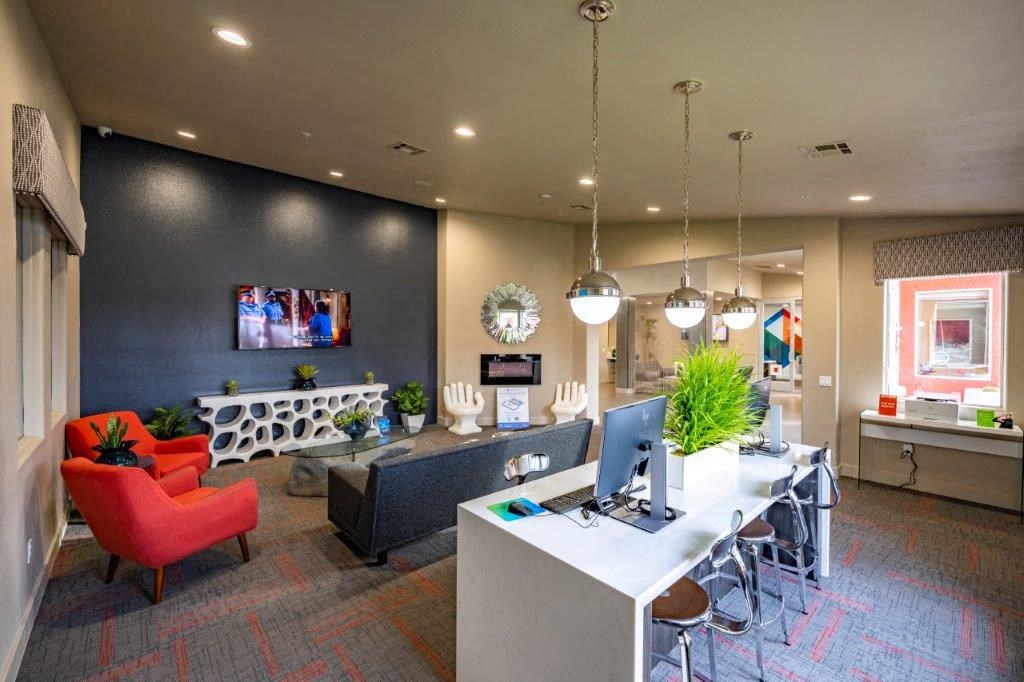 a large office with a desk and chairs and a computer