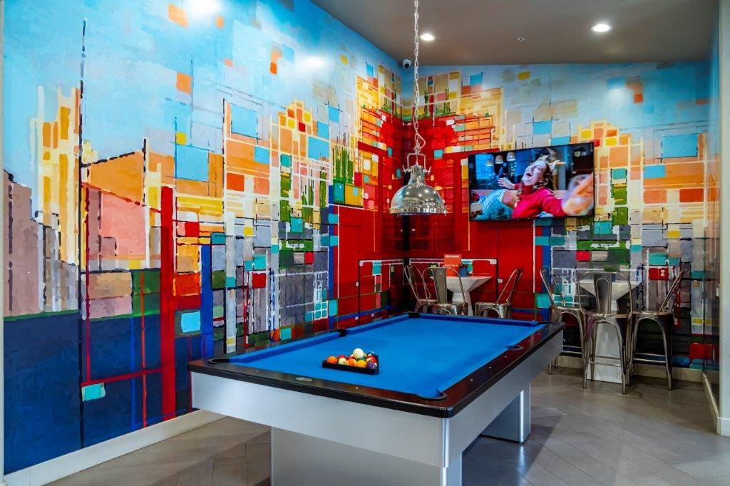 a game room with a pool table and a tv