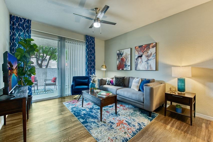 Apartments for Rent in Mesa, AZ - Envision Apartments Living Room with Wood-Style Plank Flooring and Sliding Glass Door Leading to Patio - Photo Gallery 1