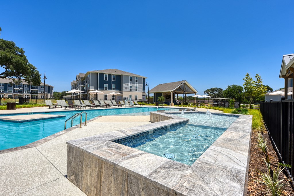 pool and hot tub at the whispering winds apartments in pearland, tx