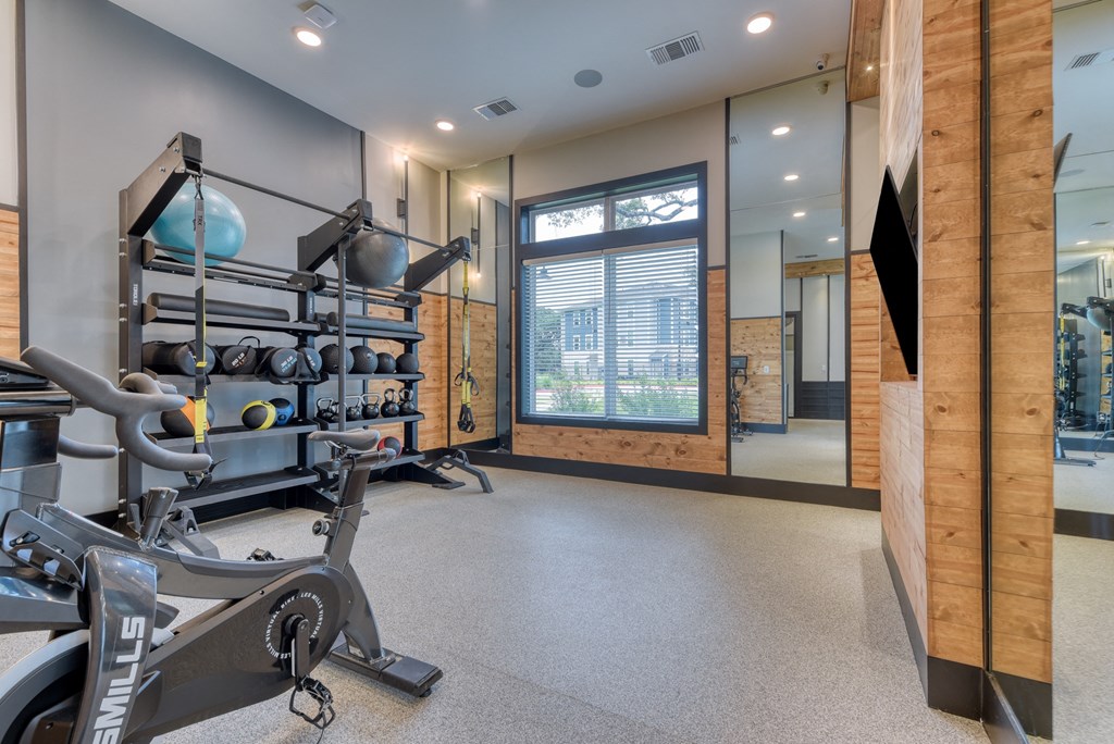 the gym at the enclave at woodbridge apartments in sugar land, tx