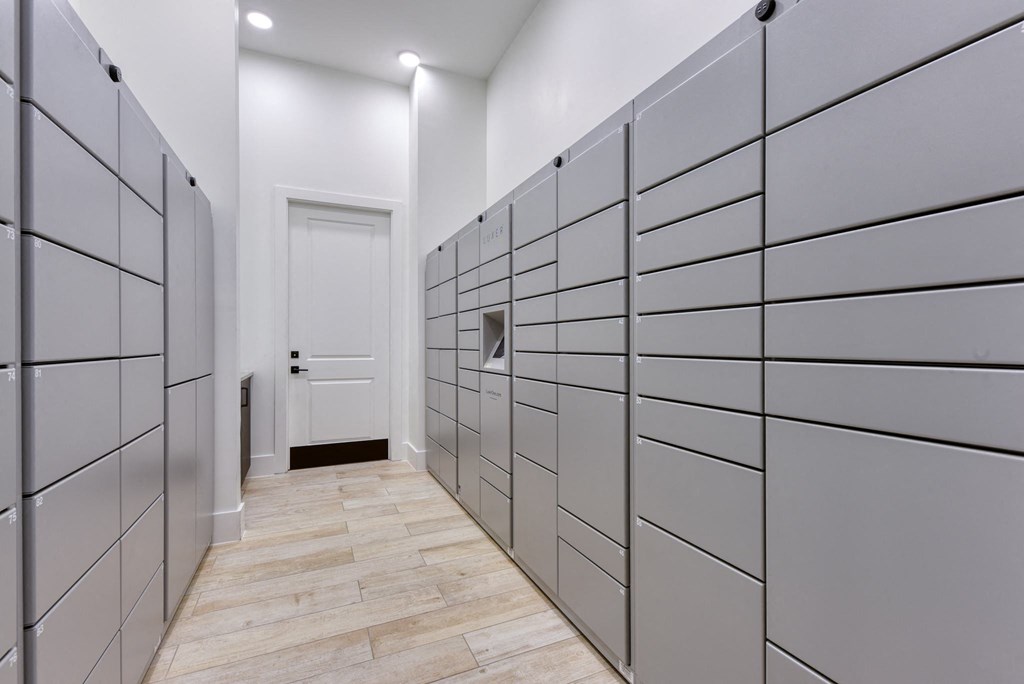 a long hallway with white walls and wooden flooring