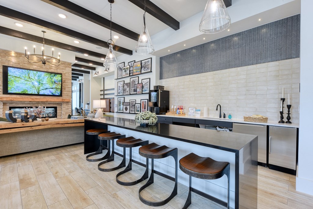 a kitchen with a long counter and stools