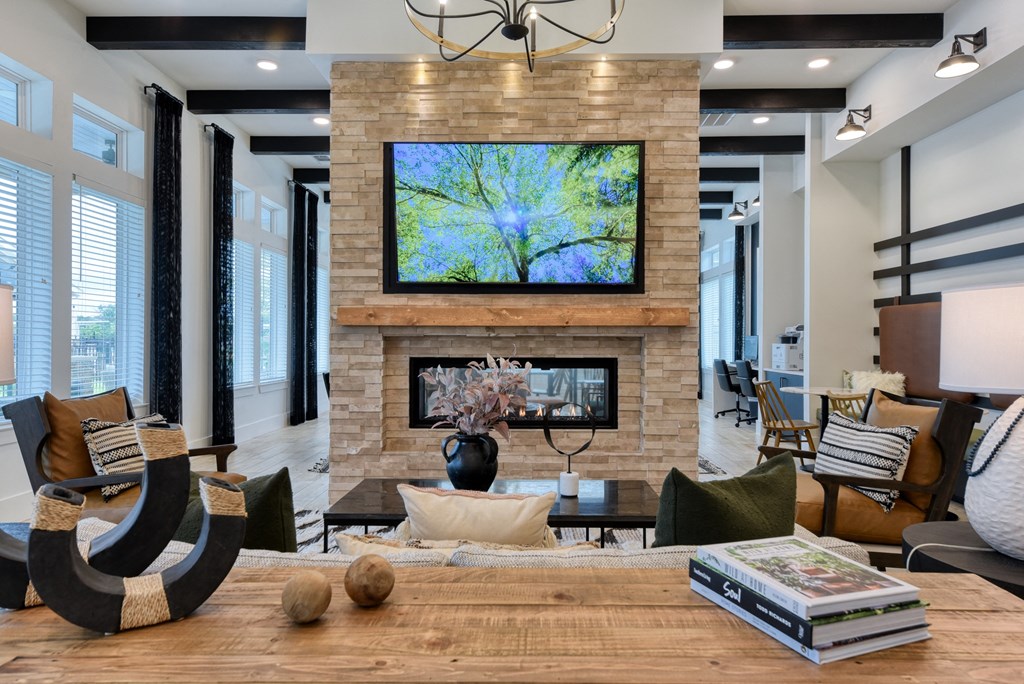 a living room with a fireplace and a tv on the wall