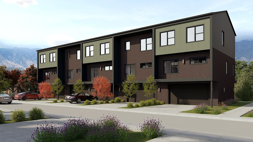 A modern apartment building with a mountain view in the background.