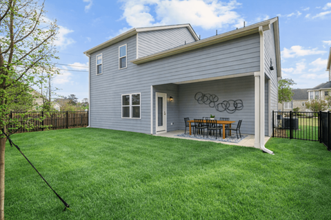 A house with a grey siding and a white door.