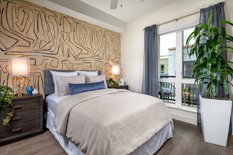 A bedroom with a large bed and a wall with a wooden pattern.