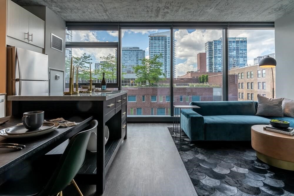 a living room and kitchen with a view of the city