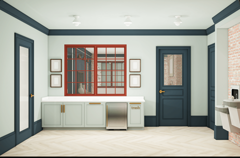 A kitchen with a red window and a trash bin.