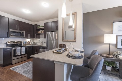 Furnished model kitchen with stainless steel appliances