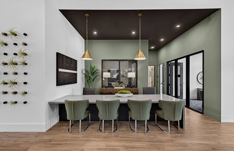 A dining room with a table set for six.