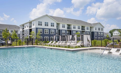 A large building with a pool in front.