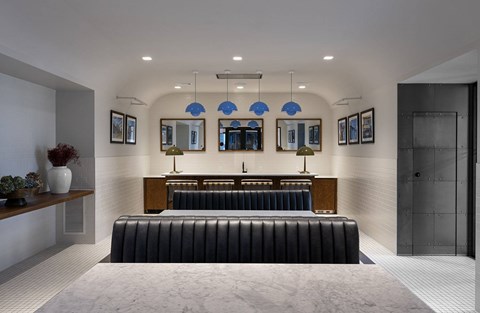 A modern bedroom with a large bed and a bench.