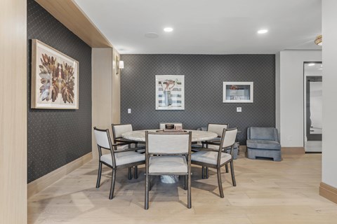 A dining room with a table set for six.