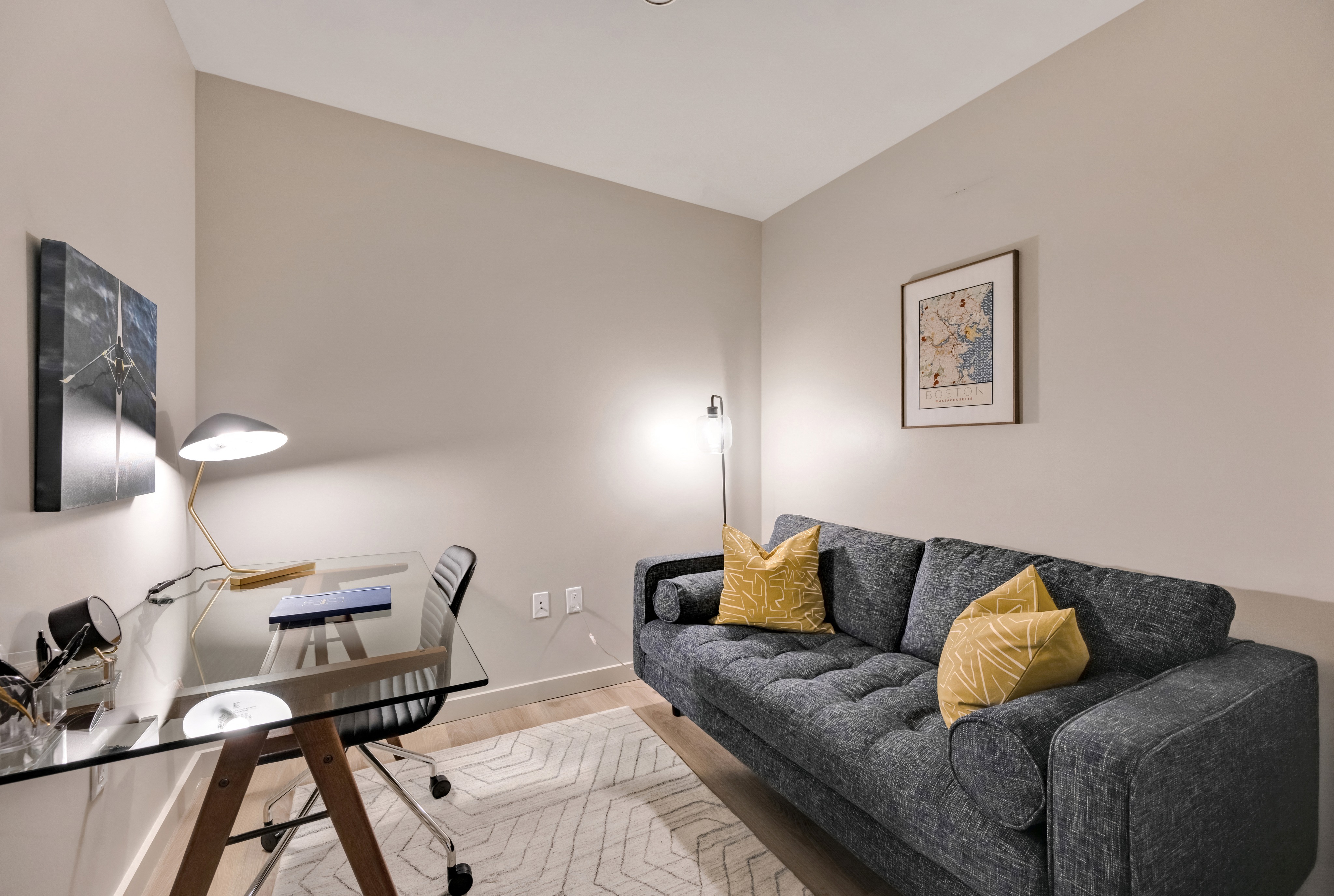 Model furnished office space with desk area and couch seating