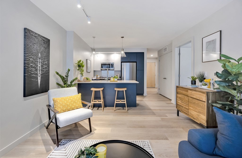 Model kitchen featuring two-tone cabinetry, stainless steel appliances, and a quartz kitchen island