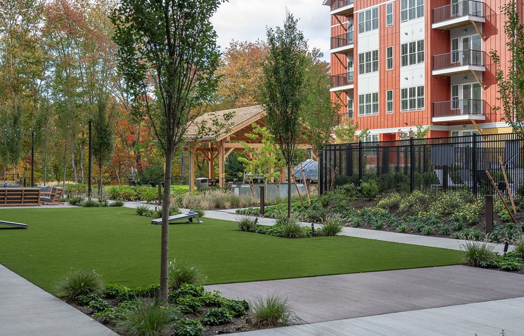 a rendering of a park with green grass and a pavilion
