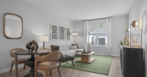 A modern living room with a green rug and a wooden table.