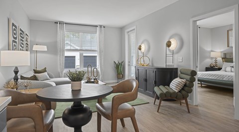 A modern dining room with a round table and chairs.