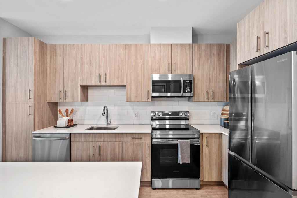 a kitchen with wooden cabinets and stainless steel appliances