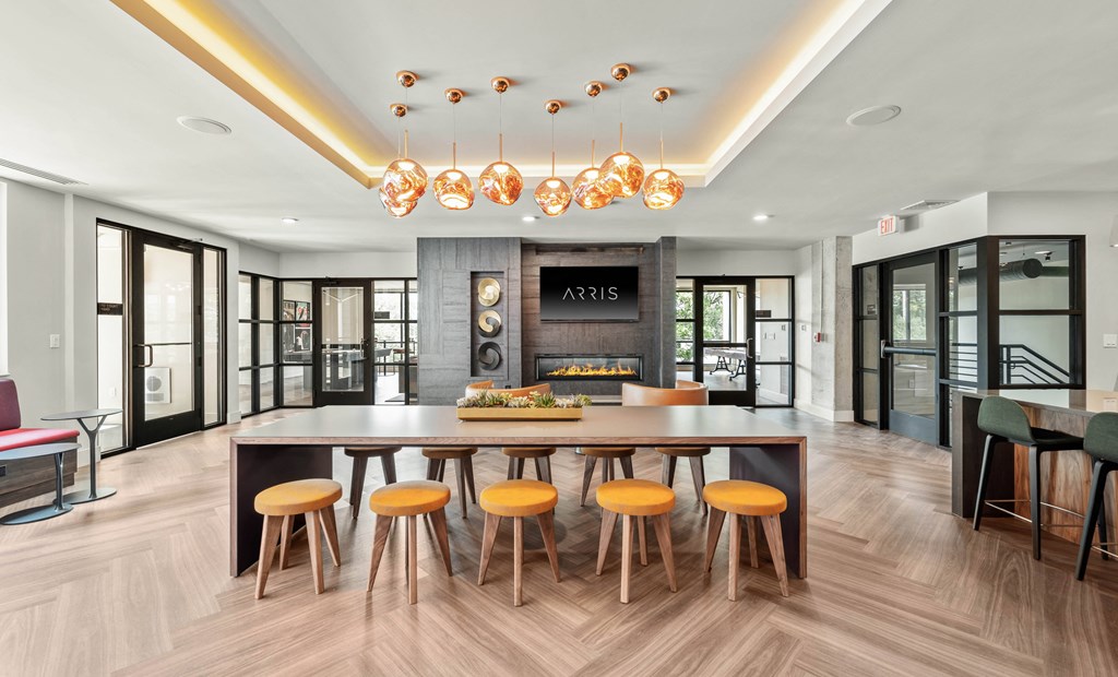 a dining room with a large table and chairs and a fireplace in the background
