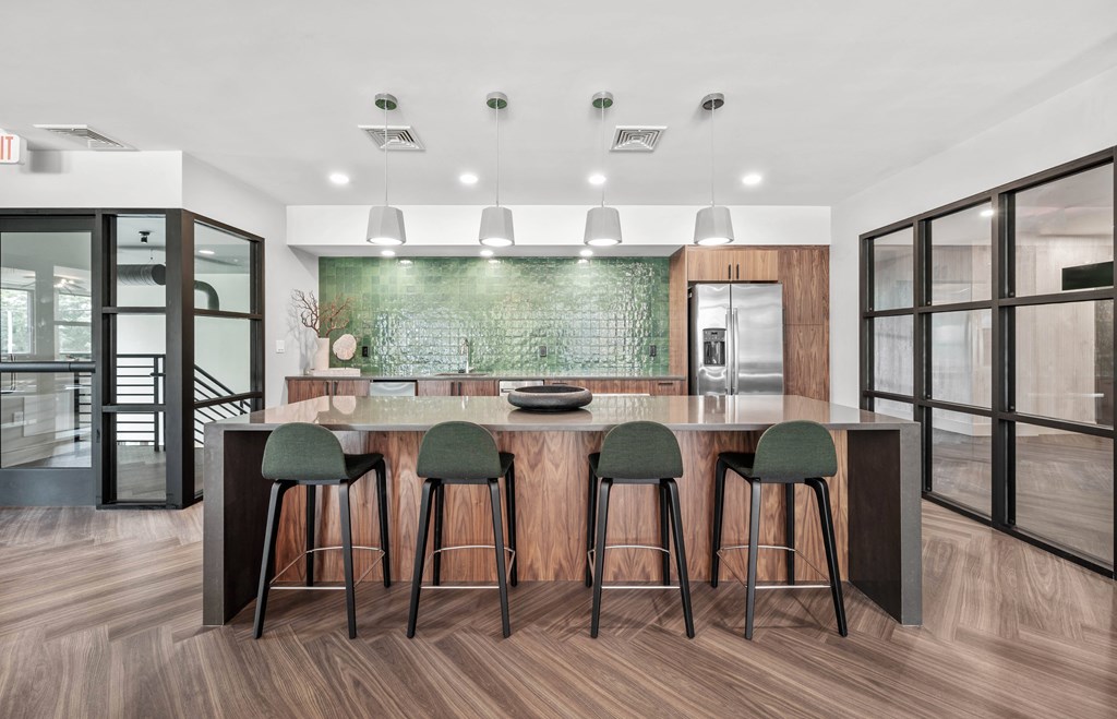 a kitchen with a large center island with four stools
