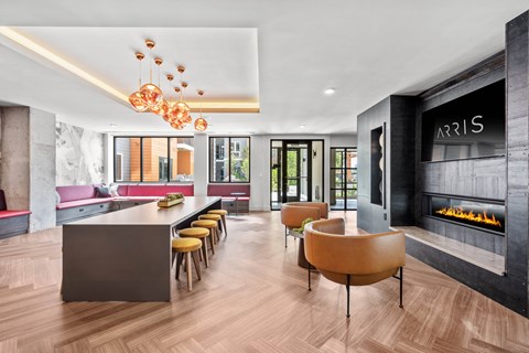 a room with a fireplace and a long table with chairs