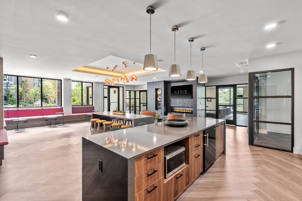 a kitchen with a large island and a dining room in the background