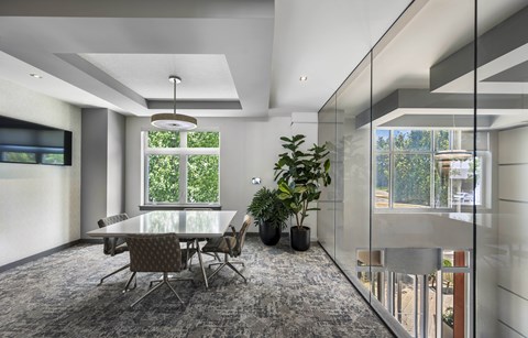 A modern dining room with a glass table and chairs.