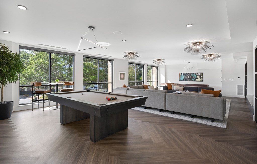 resident lounge living room with a pool table in the middle of it