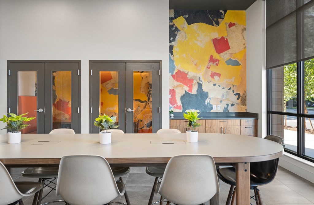 a conference room with a table and chairs and a map on the wall