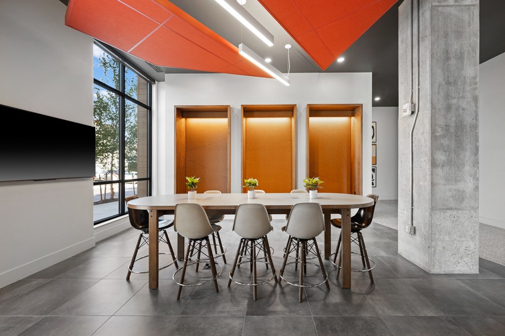 a conference room with a round table and chairs