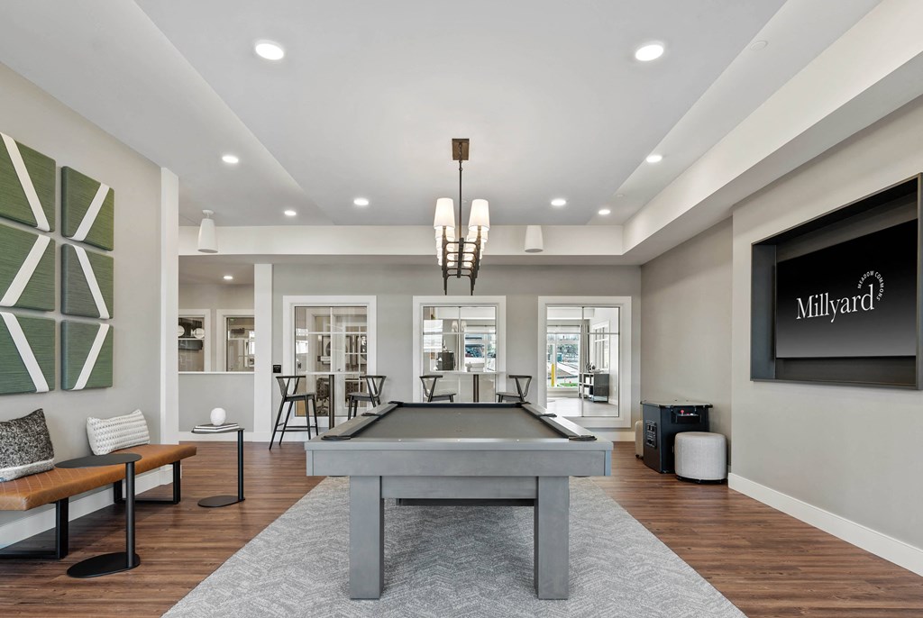 a game room with a pool table and a television