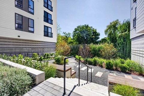 A set of stairs with railings lead up to a building.