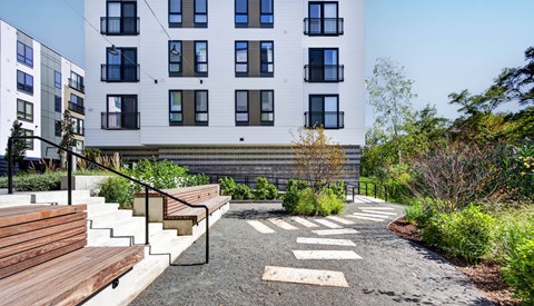 A modern building with a garden in front.