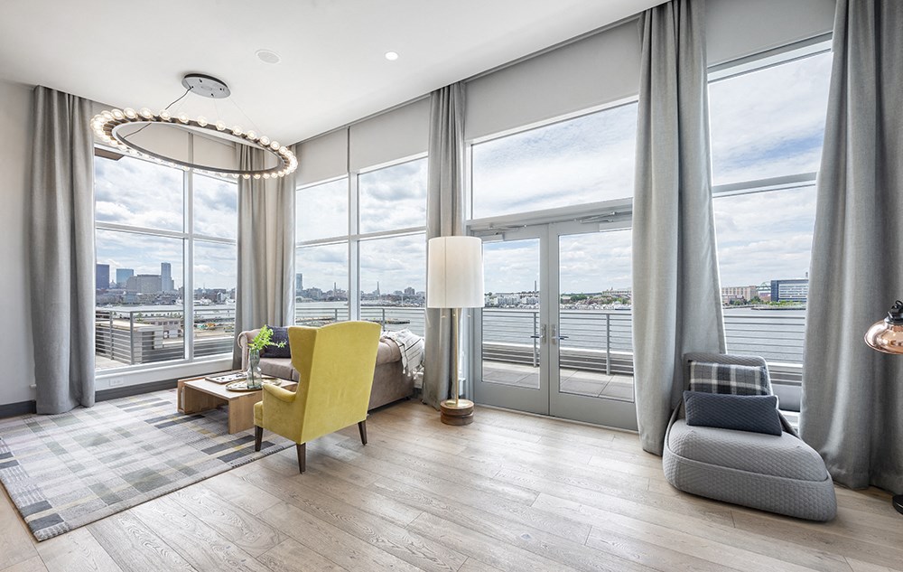 Community lounge area with a large window and a view of the city