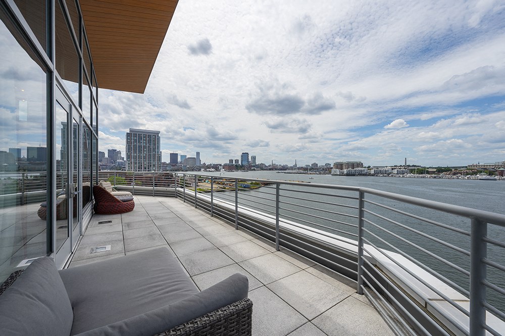 a balcony with a view of the water and a couch