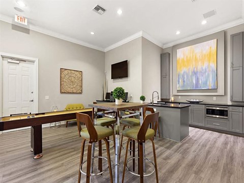 a living room with a bar and a table with chairs