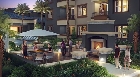 A group of people are gathered around a fire pit on a patio.