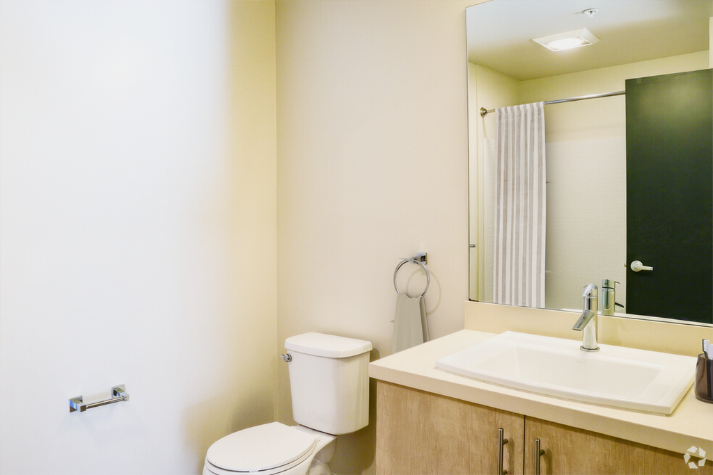 a bathroom with a sink toilet and a mirror