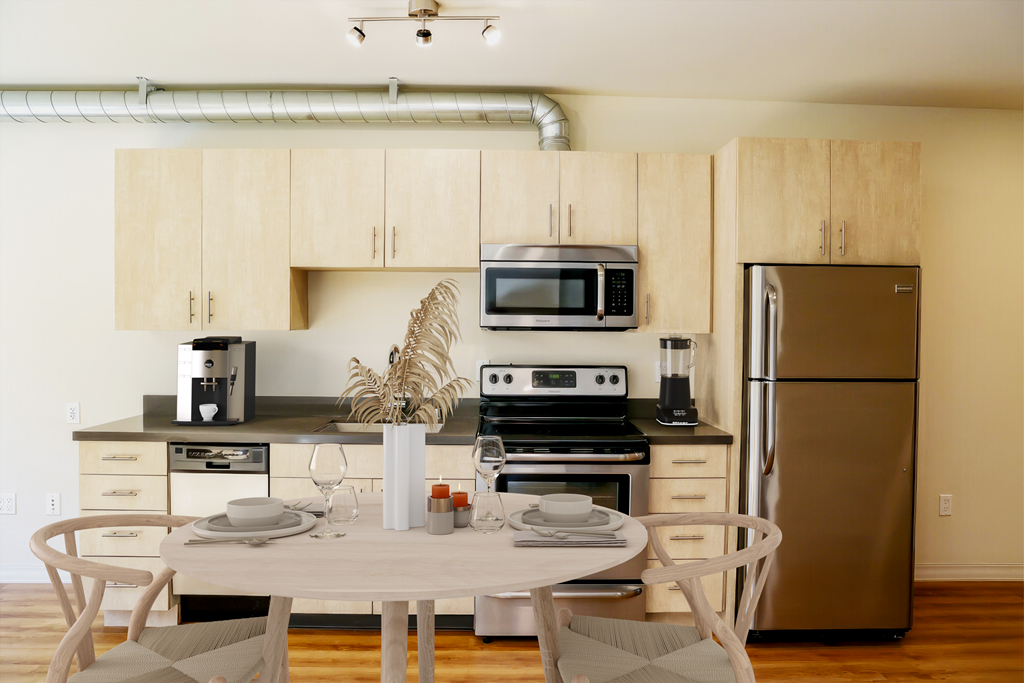a kitchen and dining area with a table and chairs