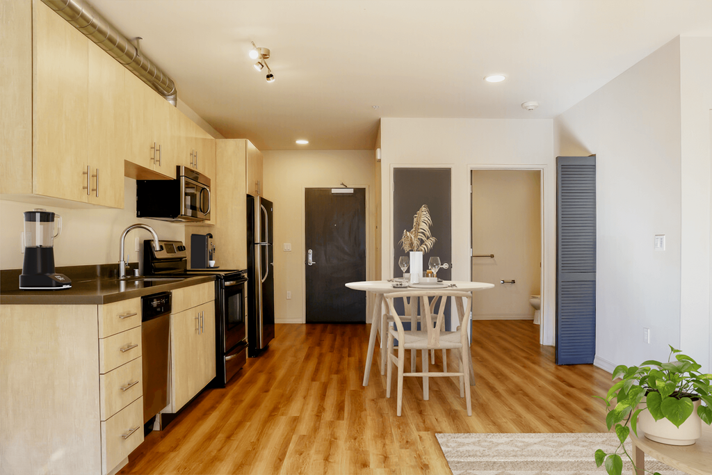 a kitchen and dining room with a white table and chairs