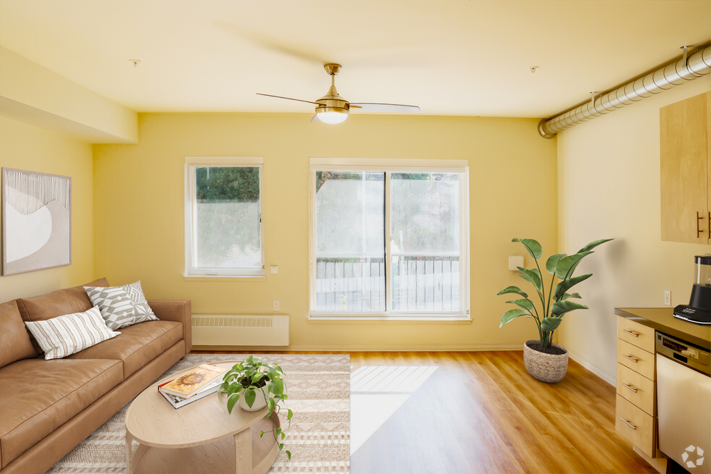 a living room with yellow walls and a couch and a coffee table