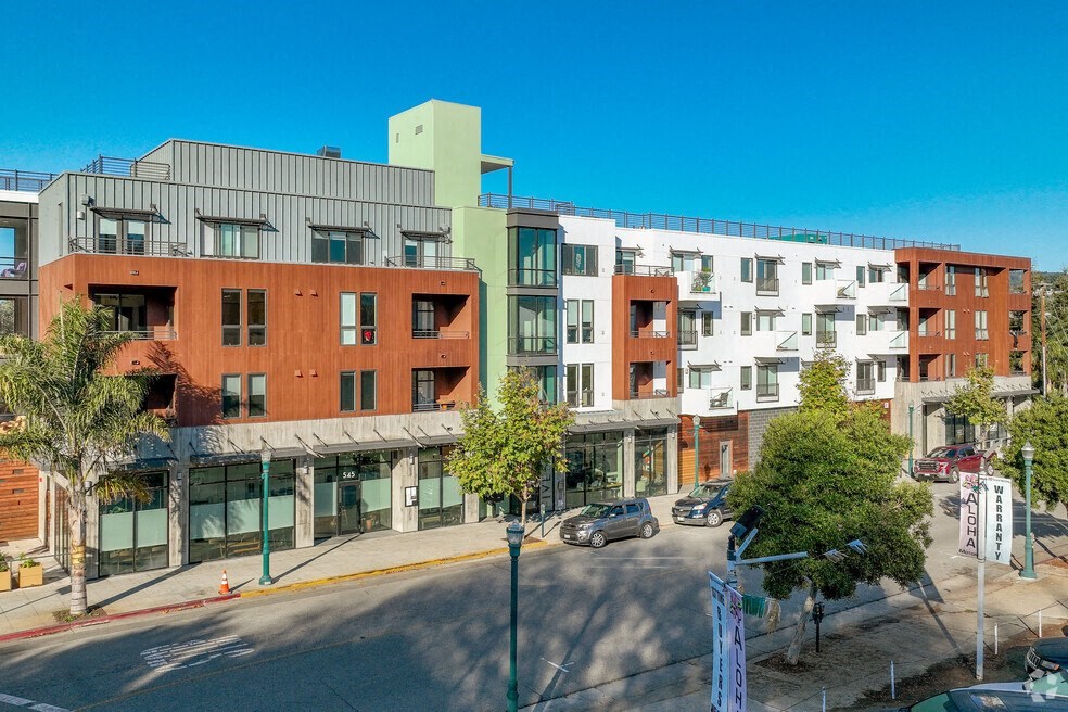 an aerial view of an apartment building on a city street