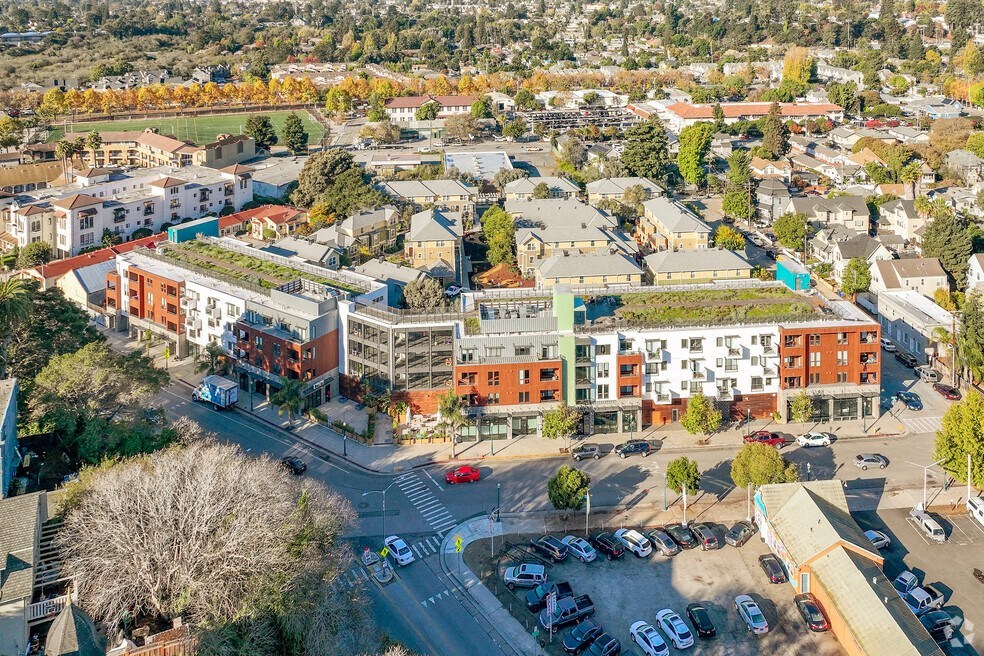an aerial view of a city with buildings and a parking lot