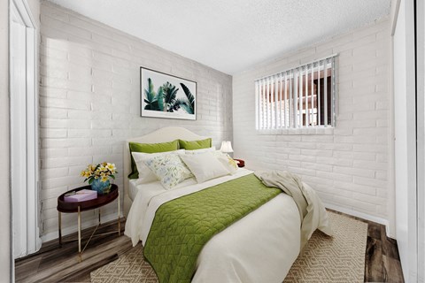 a bedroom with a bed and a green blanket