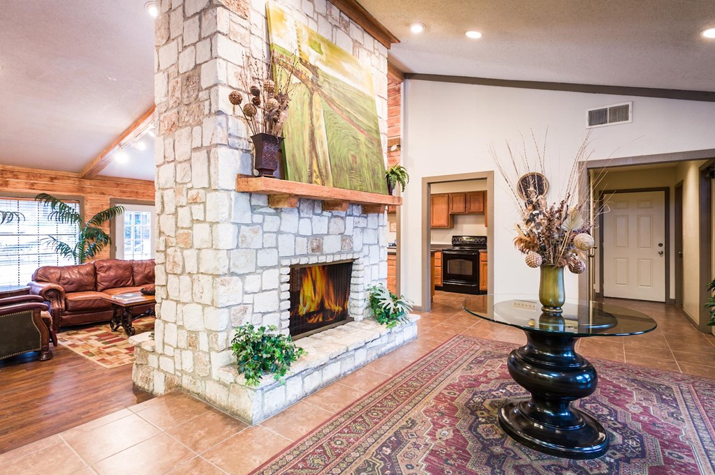 a large stone fireplace with a large painting above it