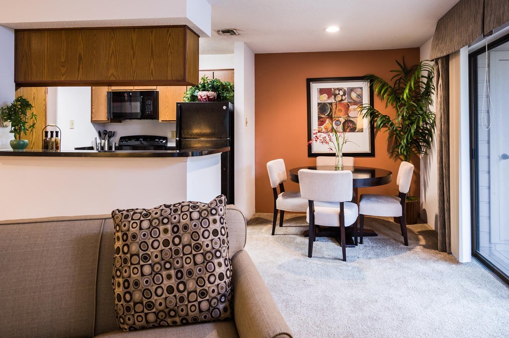 a living room with a couch a table and a microwave