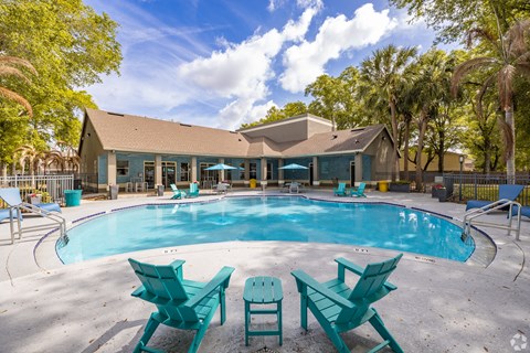 Resort style pool with turquoise lounge chairs at Fusion Apartments, Orlando, FL 32818
